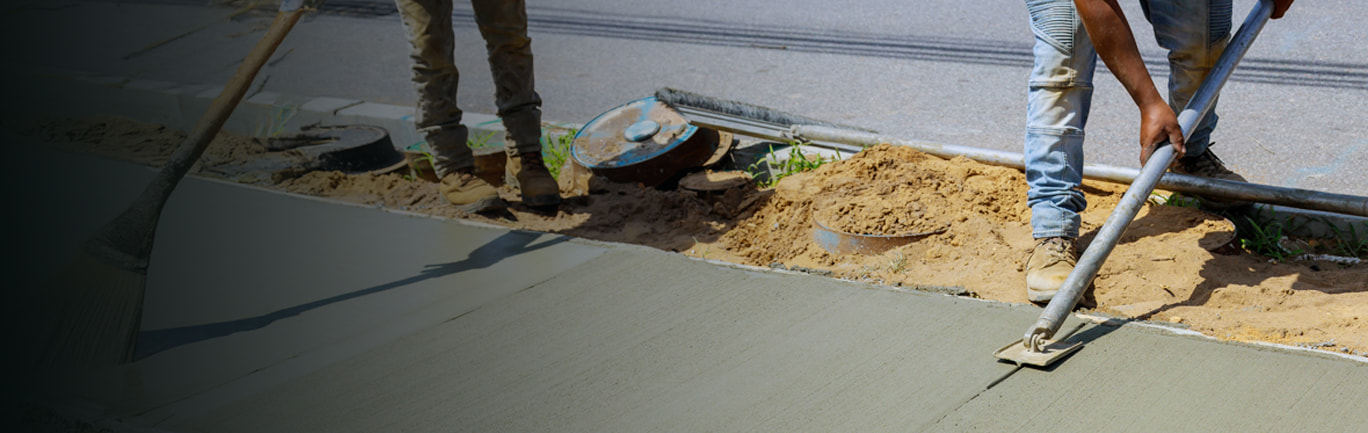 construction crew smoothing fresh cement